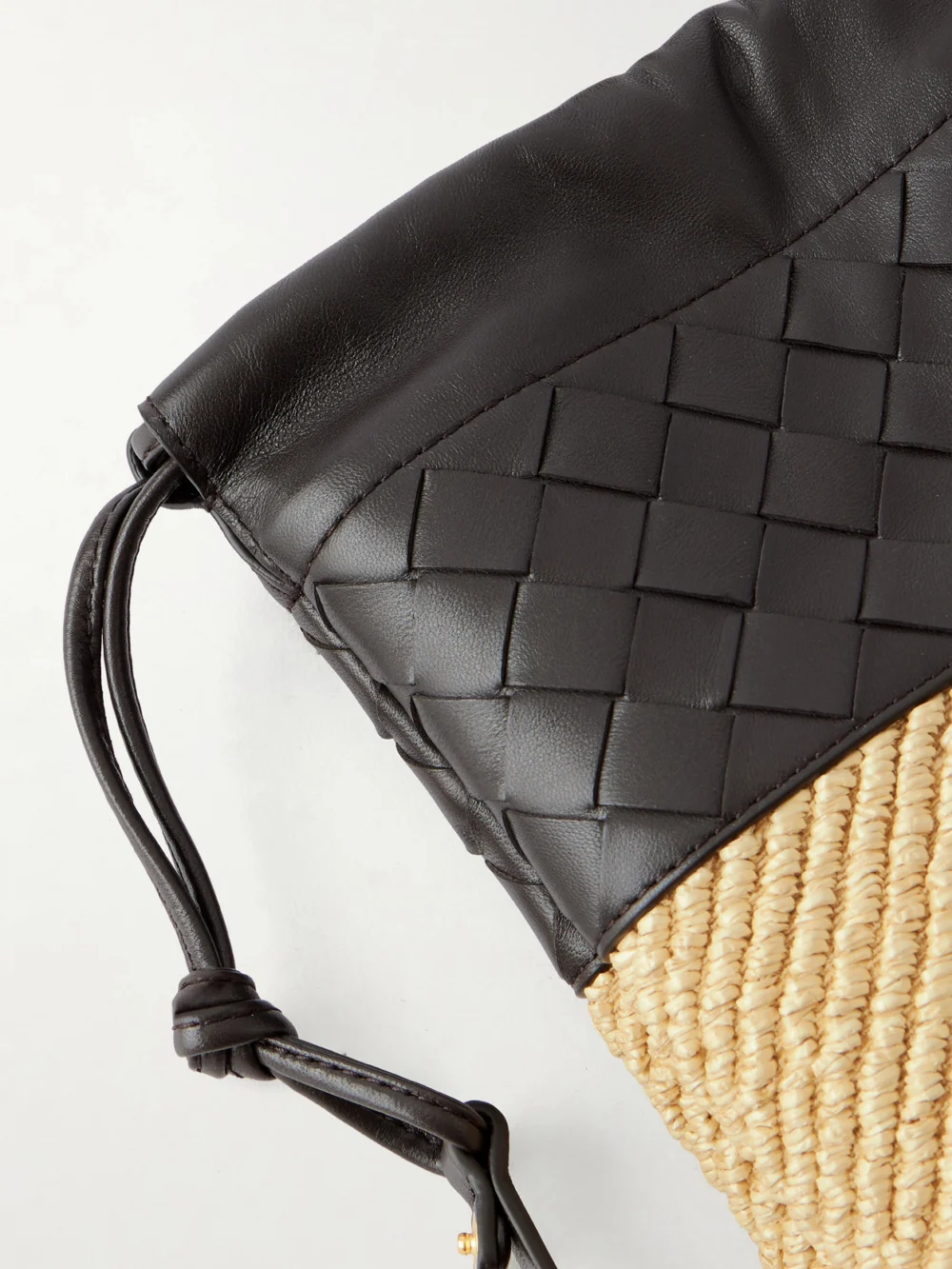 Close-up detail of the Bottega Veneta Dustbag Medium Intrecciato Leather and Raffia Clutch