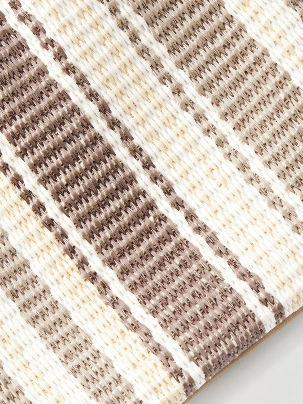 Close-up detail of the Brunello Cucinelli Striped Leather-trimmed Raffia Shoulder Bag