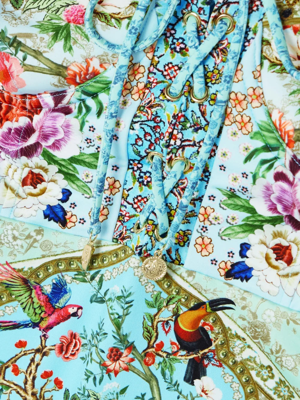 Close-up detail of the Camilla Lace-up Crystal-embellished Printed Recycled Swimsuit