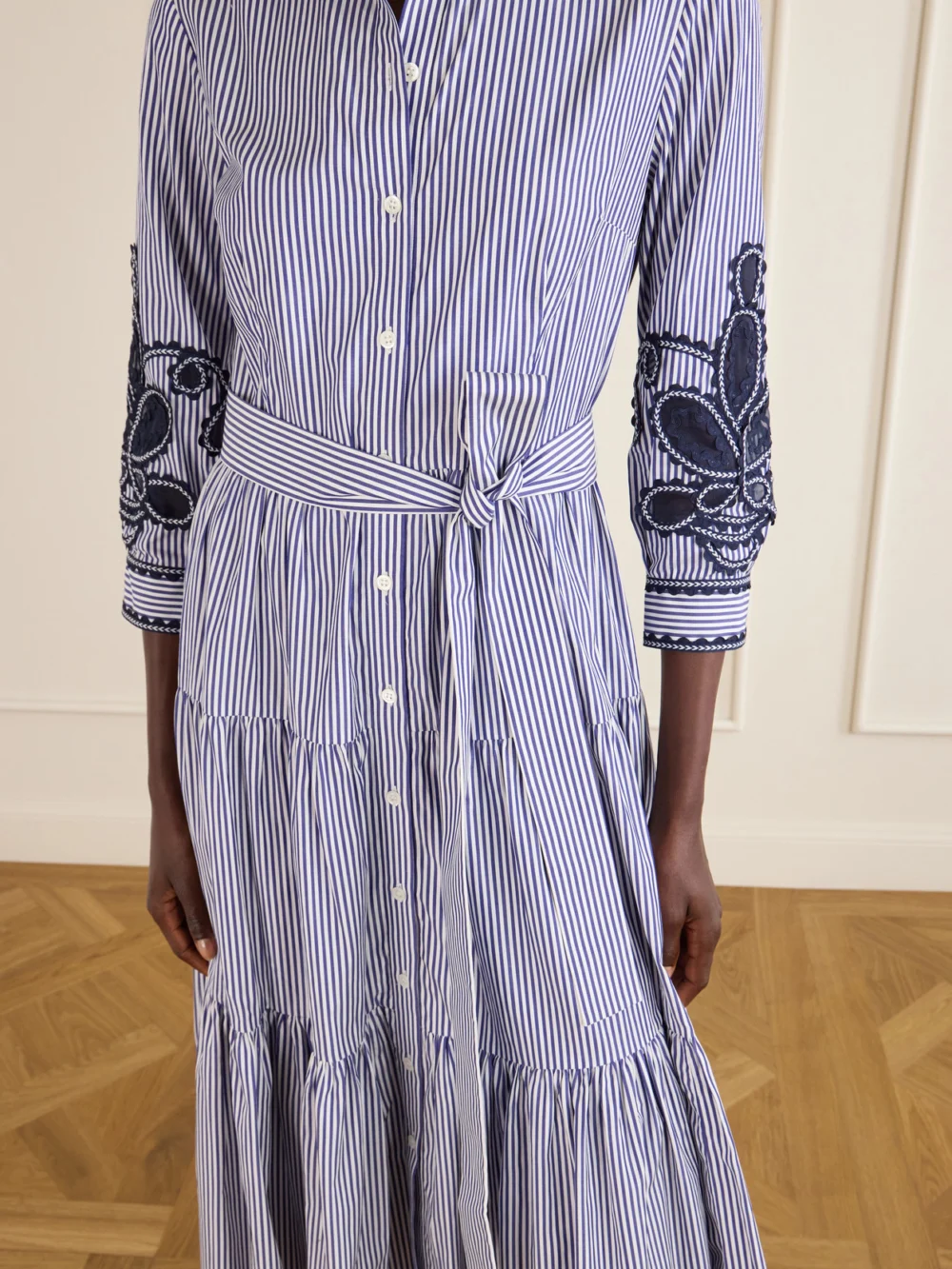 Close-up detail of the Carolina Herrera Belted Tiered Embroidered Striped Cotton-poplin Midi Dress