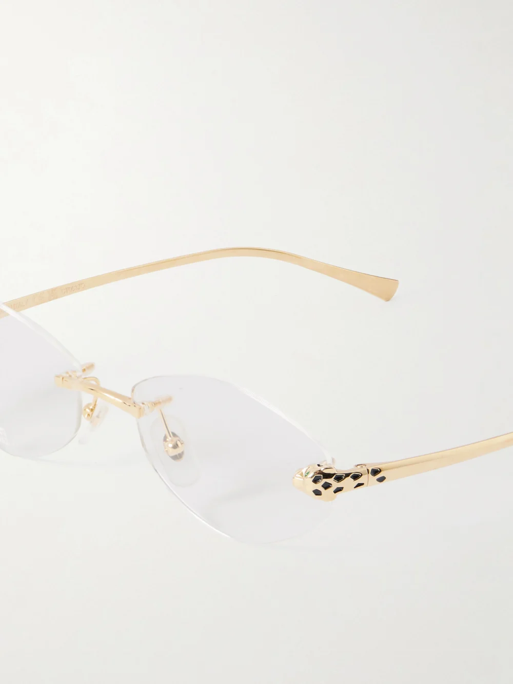 Close-up detail of the Cartier Eyewear Panthère De Cartier Hexagon-frame Gold-tone Optical Glasses