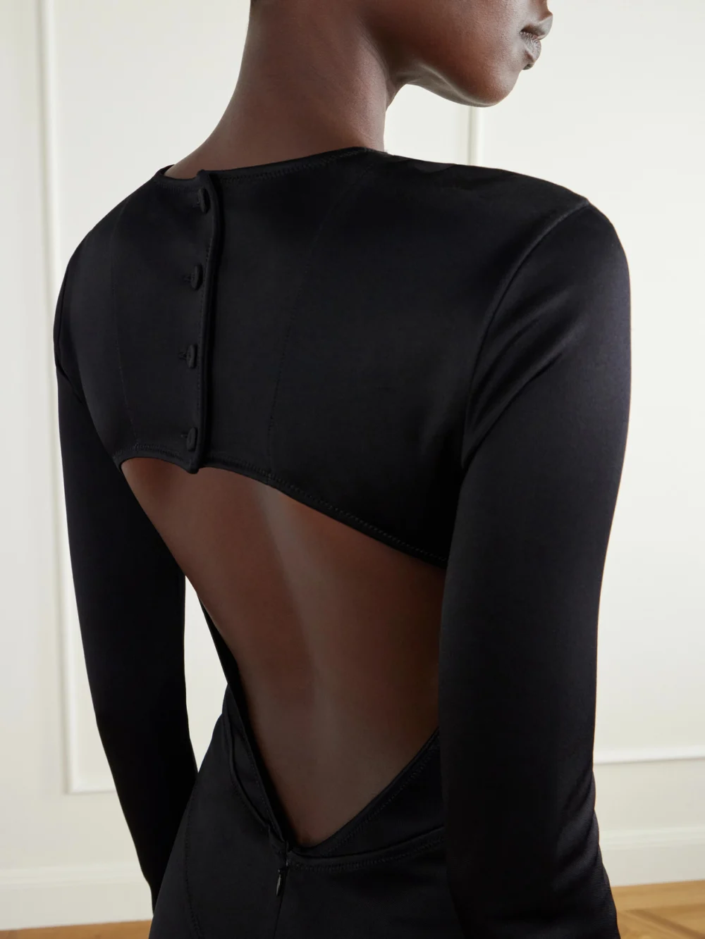 Close-up detail of the Co Backless Paneled Satin Maxi Dress