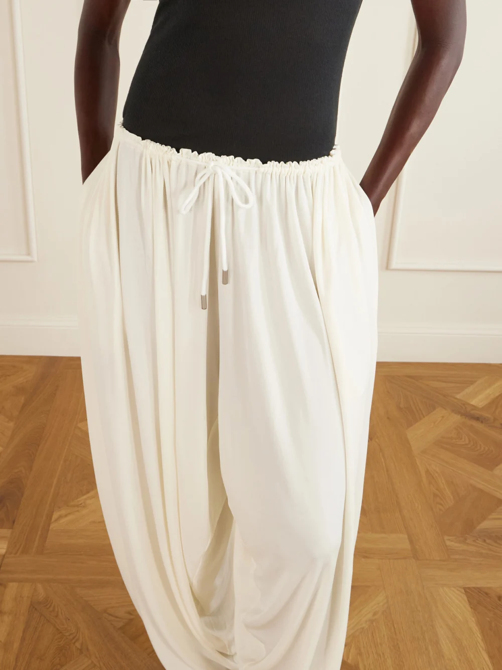 Close-up detail of the Co Gathered Satin Wide-leg Pants