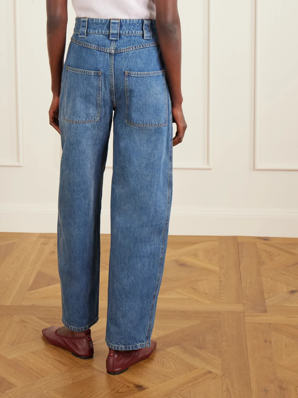 Back view of the Co Paneled Mid-rise Barrel-leg Jeans