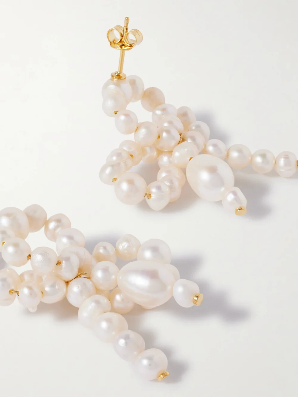 Close-up detail of the Completedworks Gold-plated Recycled Silver Pearl Earrings