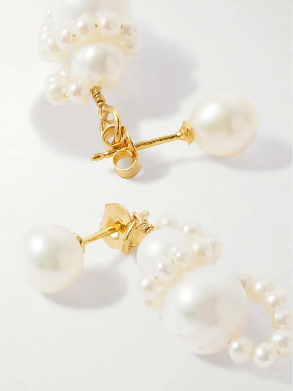 Close-up detail of the Completedworks Recycled Gold-plated Pearl Earrings
