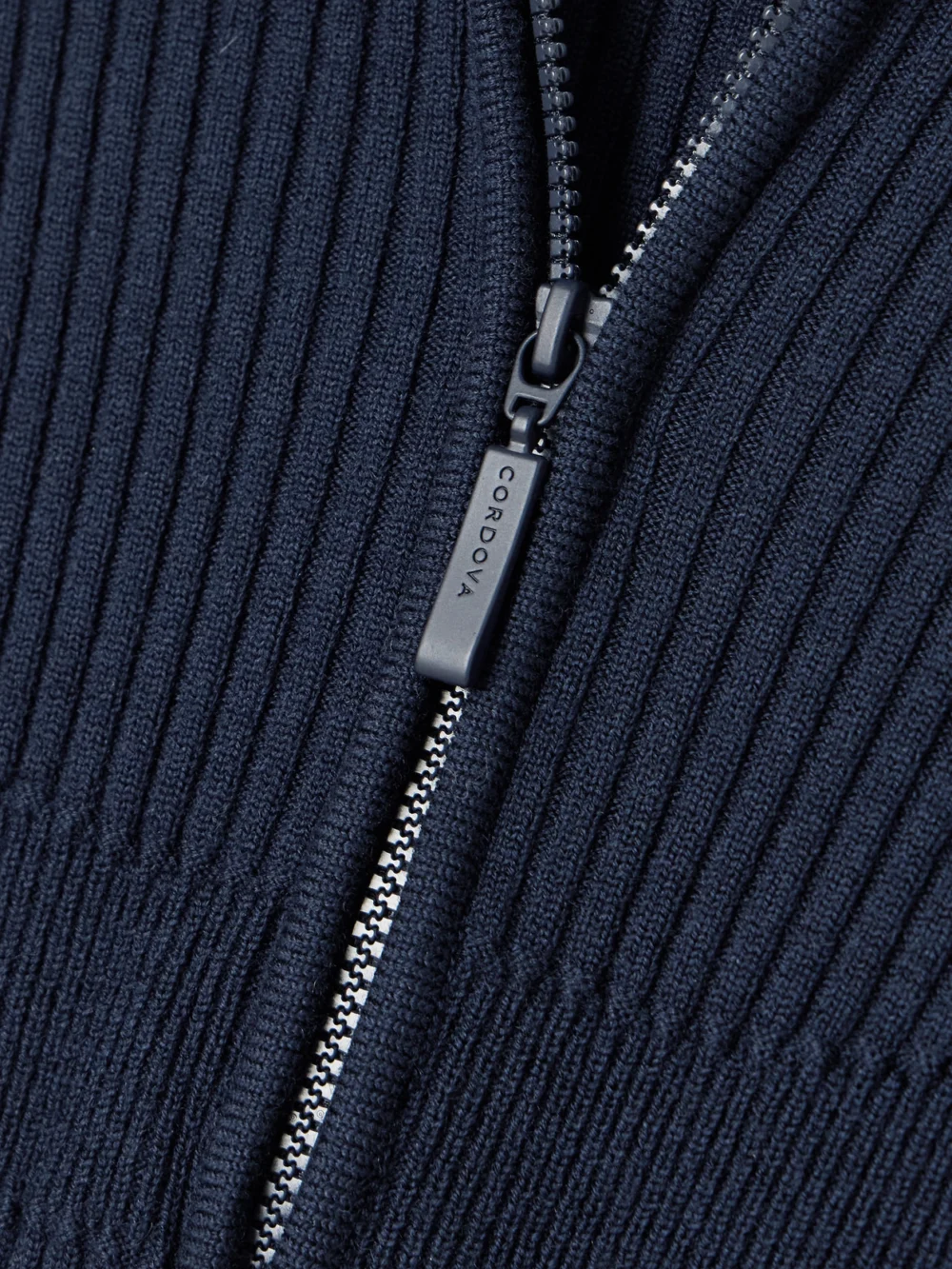 Close-up detail of the Cordova Butte Ribbed Merino-wool Turtleneck Bodysuit