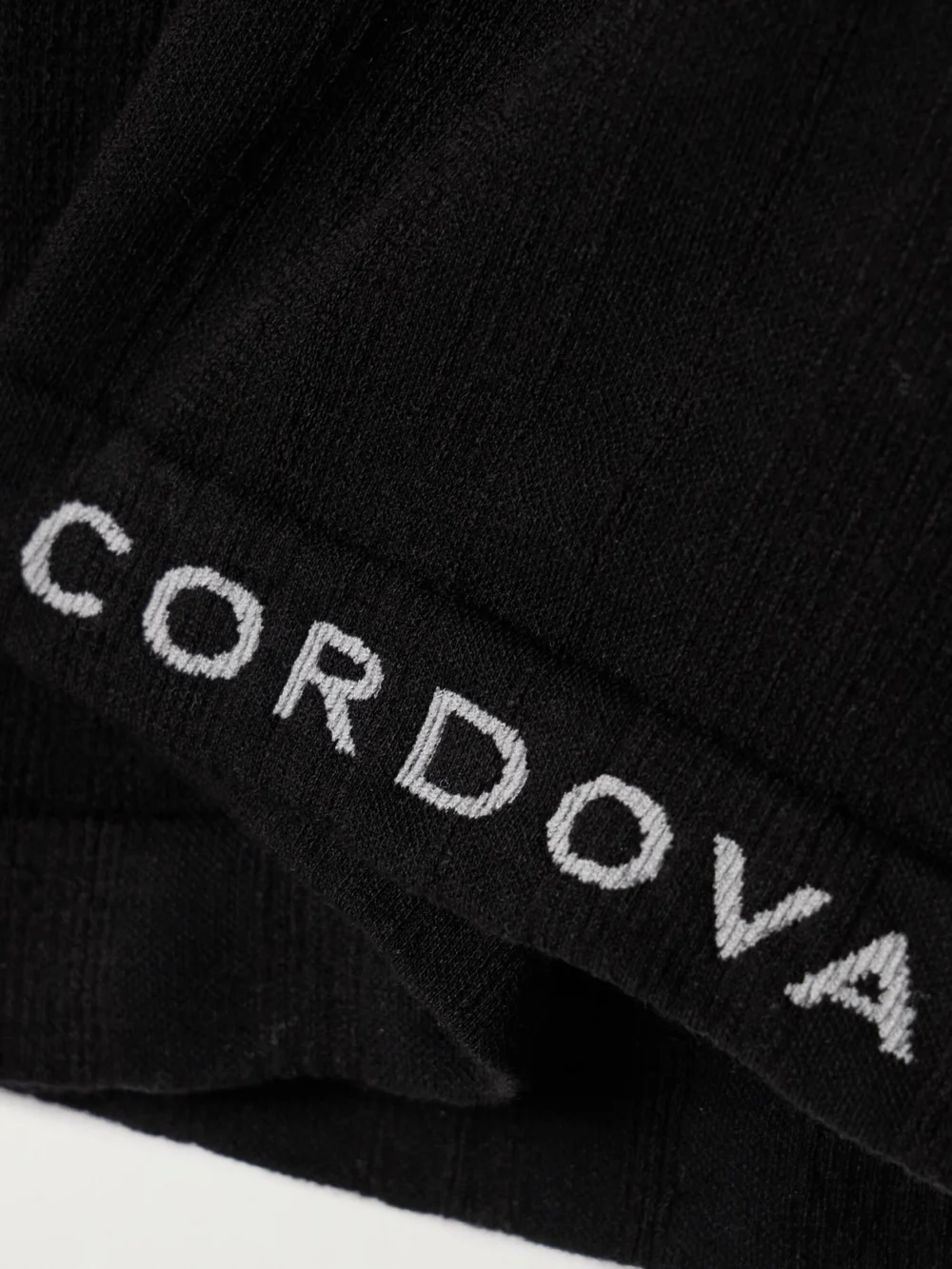 Close-up detail of the Cordova Sol Ribbed Stretch-jersey Turtleneck Top
