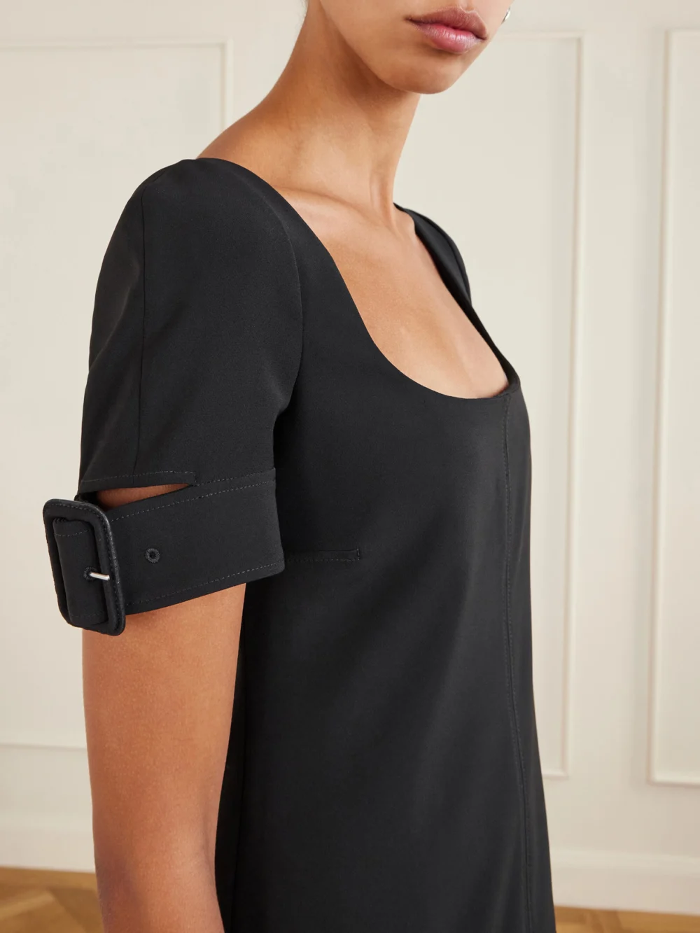Close-up detail of the Courrèges Buckled Crepe Mini Dress