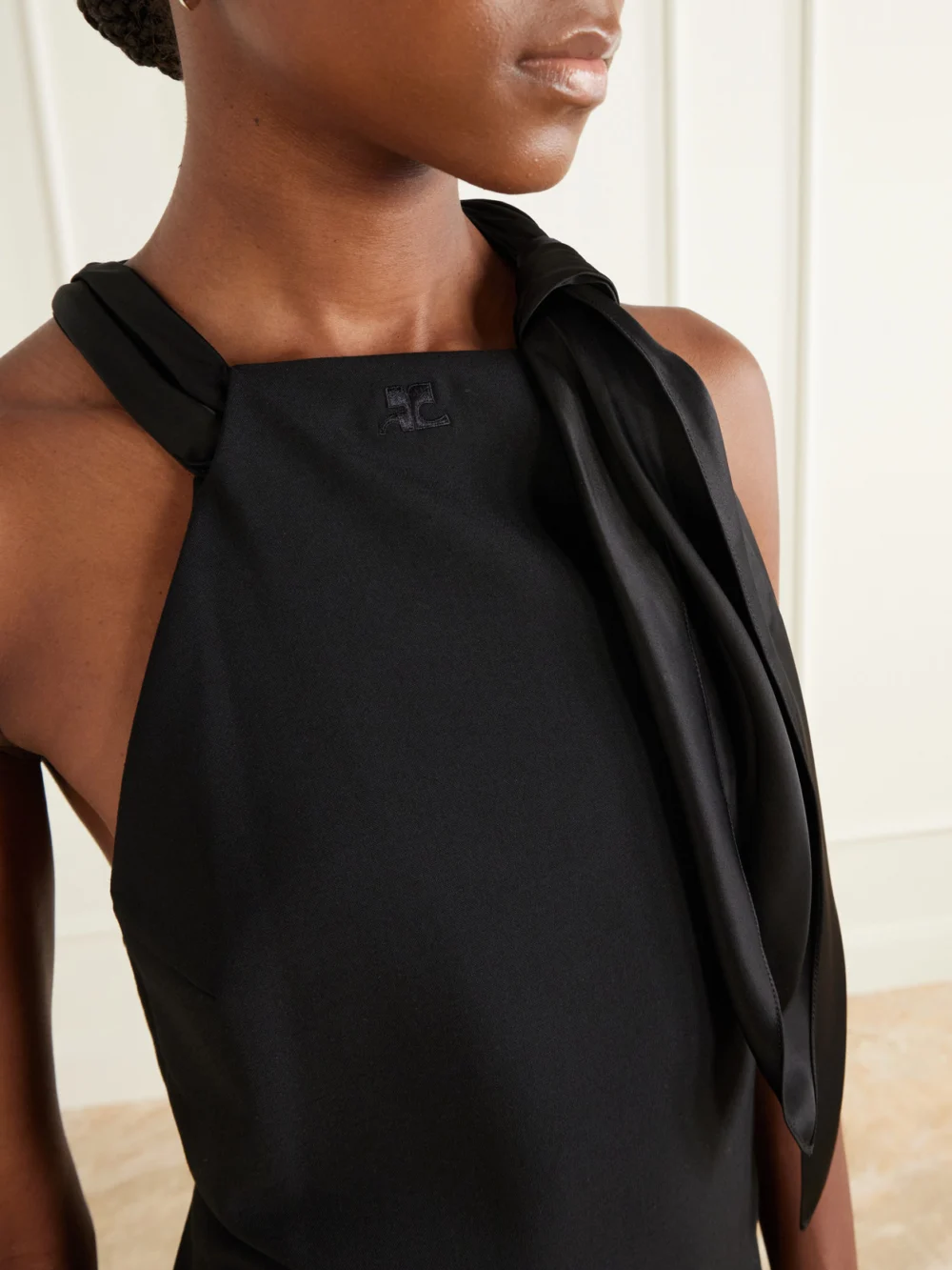 Close-up detail of the Courrèges Tie-detailed Logo-embroidered Crepe Mini Dress