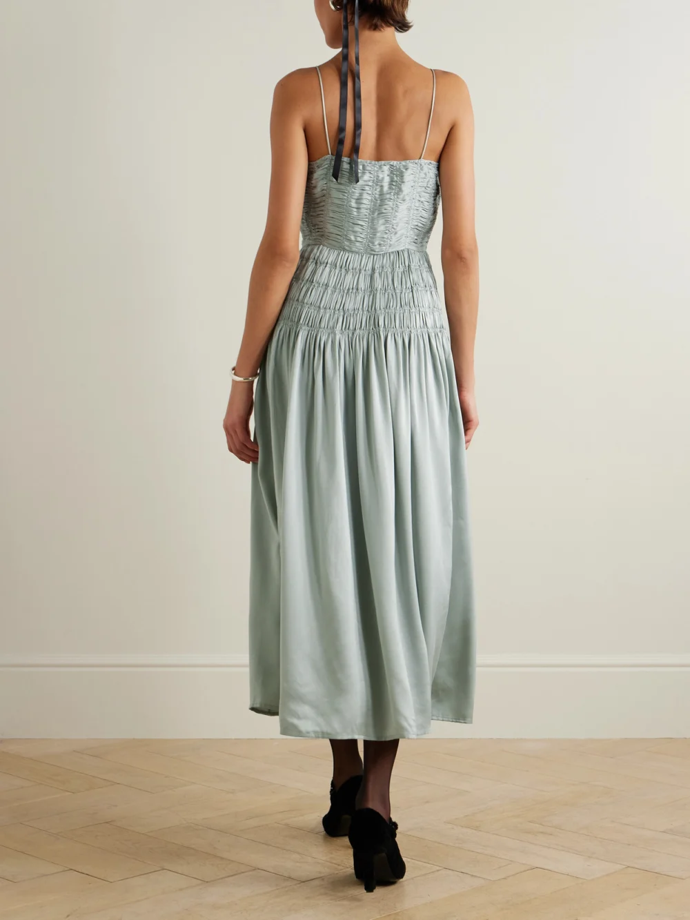 Back view of the Dôen Ambrosia Bow-detailed Shirred Silk-satin Midi Dress