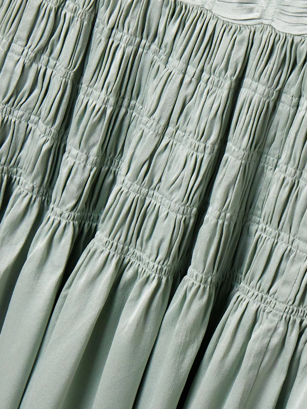 Close-up detail of the Dôen Ambrosia Bow-detailed Shirred Silk-satin Midi Dress