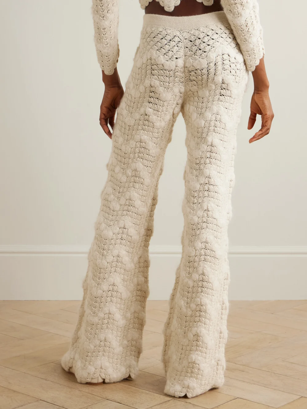 Back view of the Escvdo Brisa Scalloped Crocheted Alpaca Wide-leg Pants