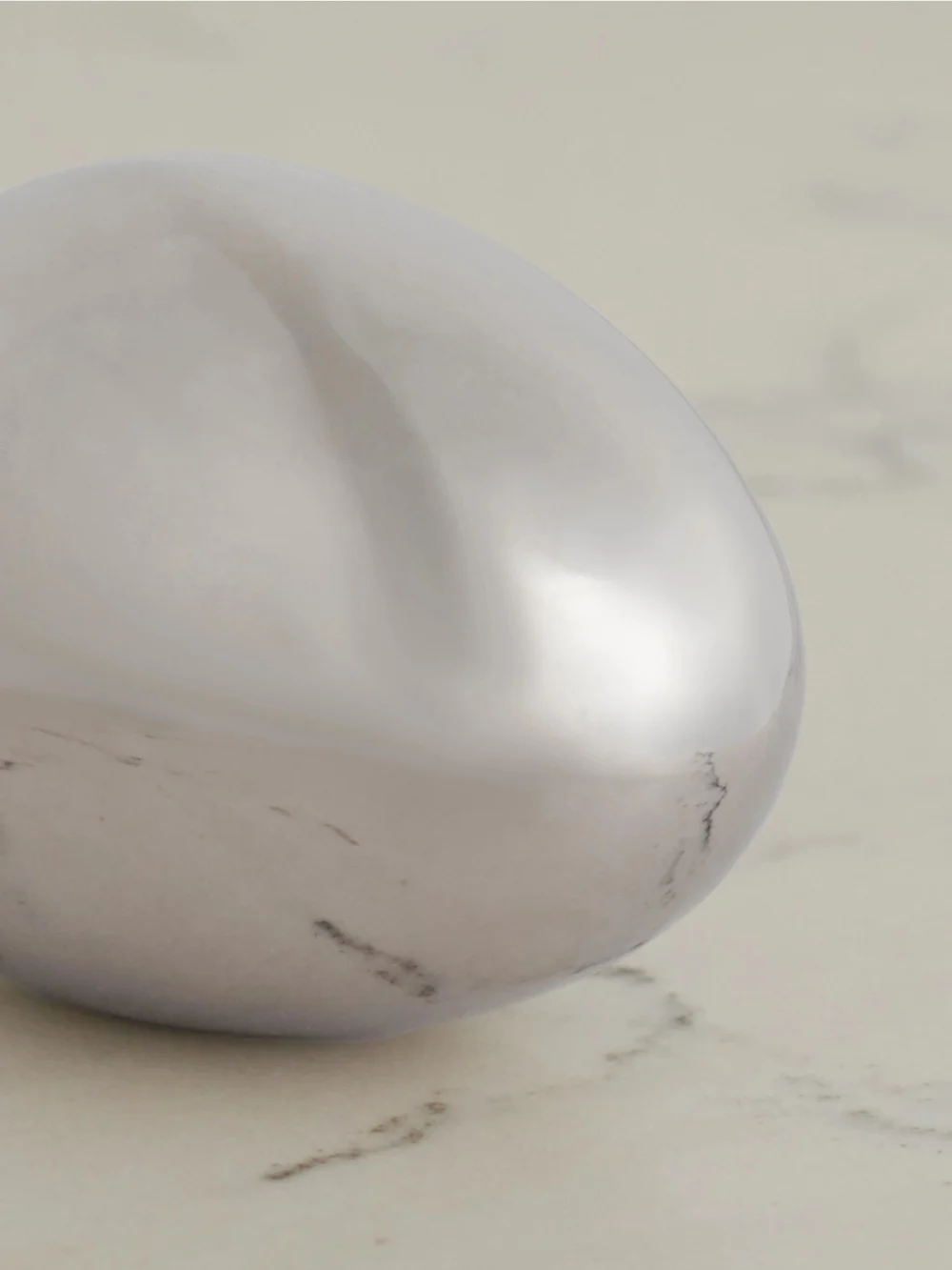 Close-up detail of the Fourth Street Egg Steel Paperweight