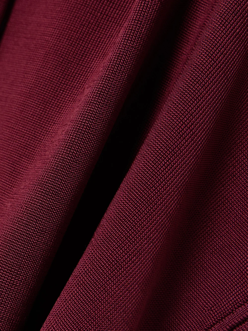 Close-up detail of the Galvan Pierced Embellished Asymmetric Knitted Top