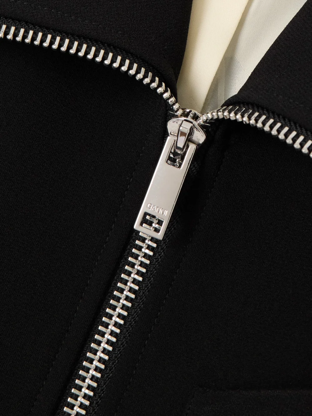 Close-up detail of the Ganni Paneled Ruffled Crepe Mini Dress