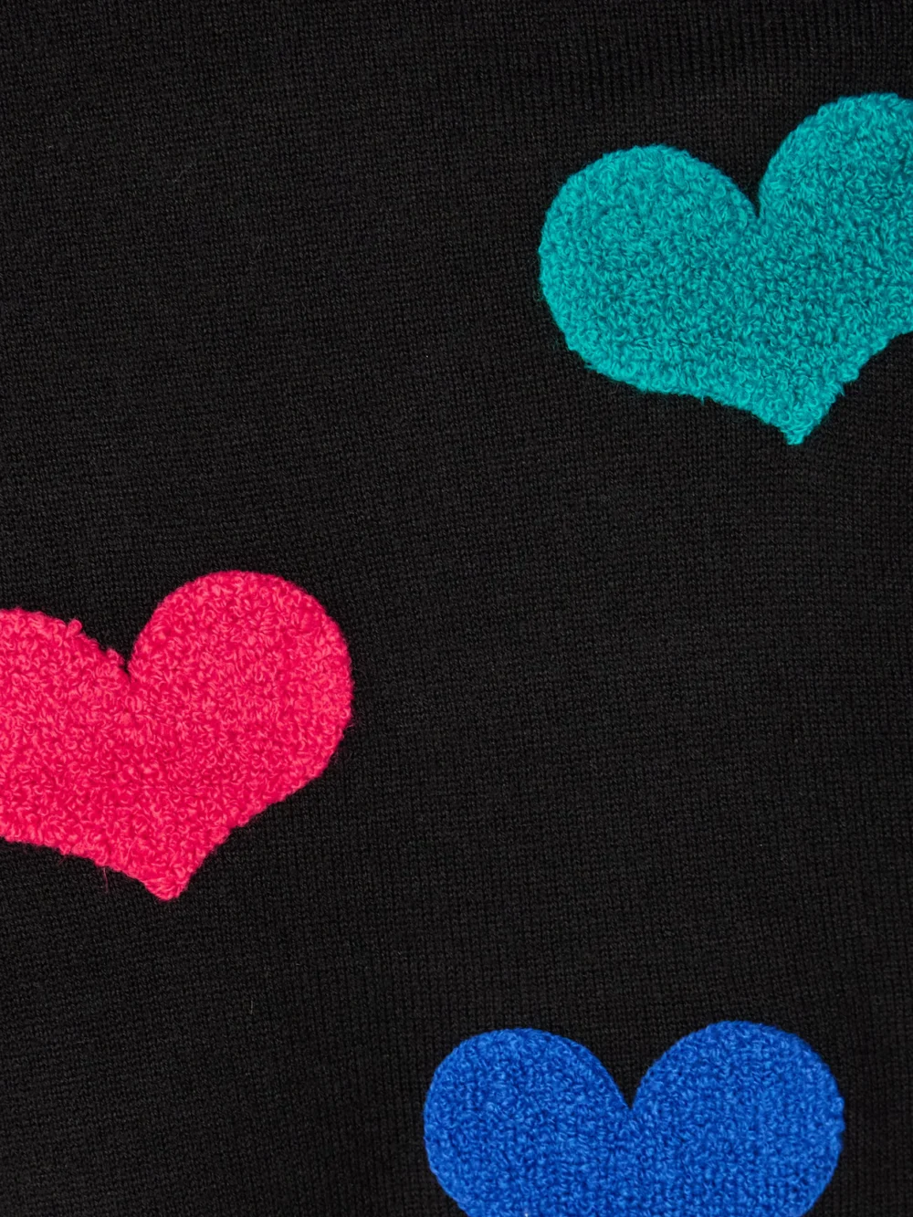 Close-up detail of the Goldbergh Bacio Appliquéd Knitted Turtleneck Sweater