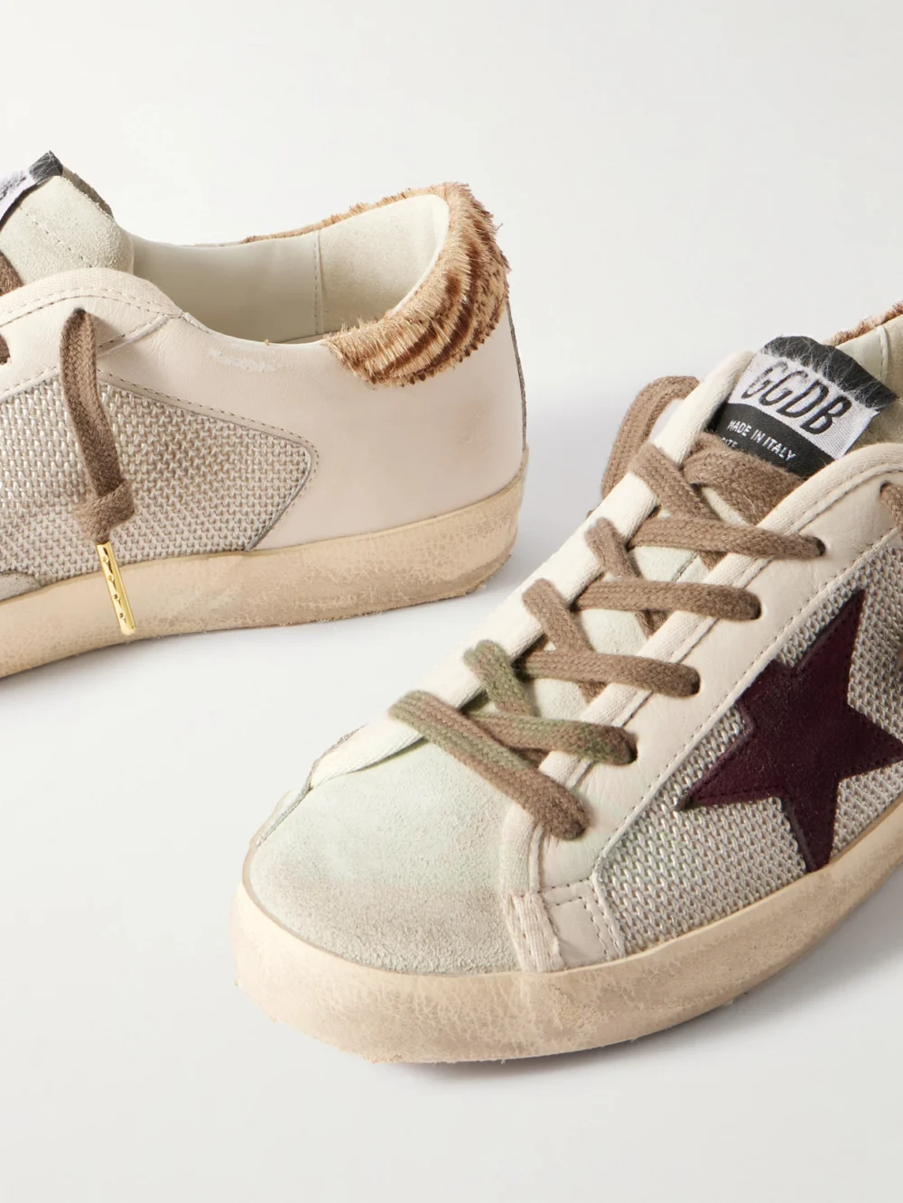 Close-up detail of the Golden Goose Super-star Calf Hair and Suede-trimmed Mesh and Distressed Leather Sneakers