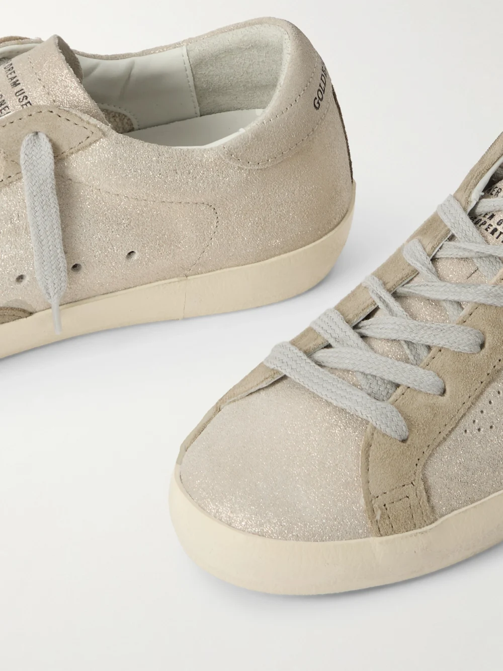 Close-up detail of the Golden Goose Super-star Distressed Glittered Suede Sneakers