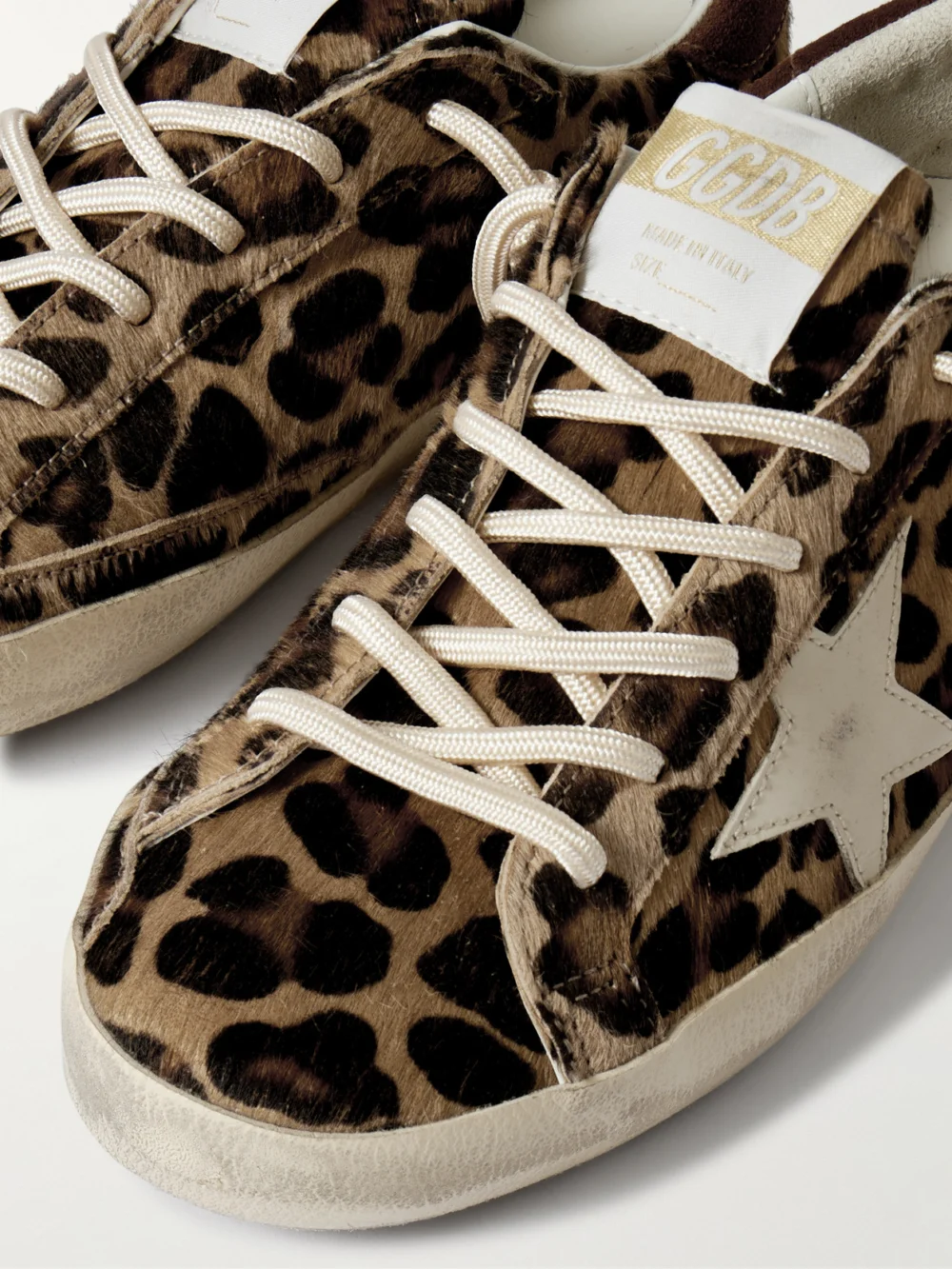 Close-up detail of the Golden Goose Super-star Distressed Leather and Suede-trimmed Leopard-print Calf Hair Sneakers