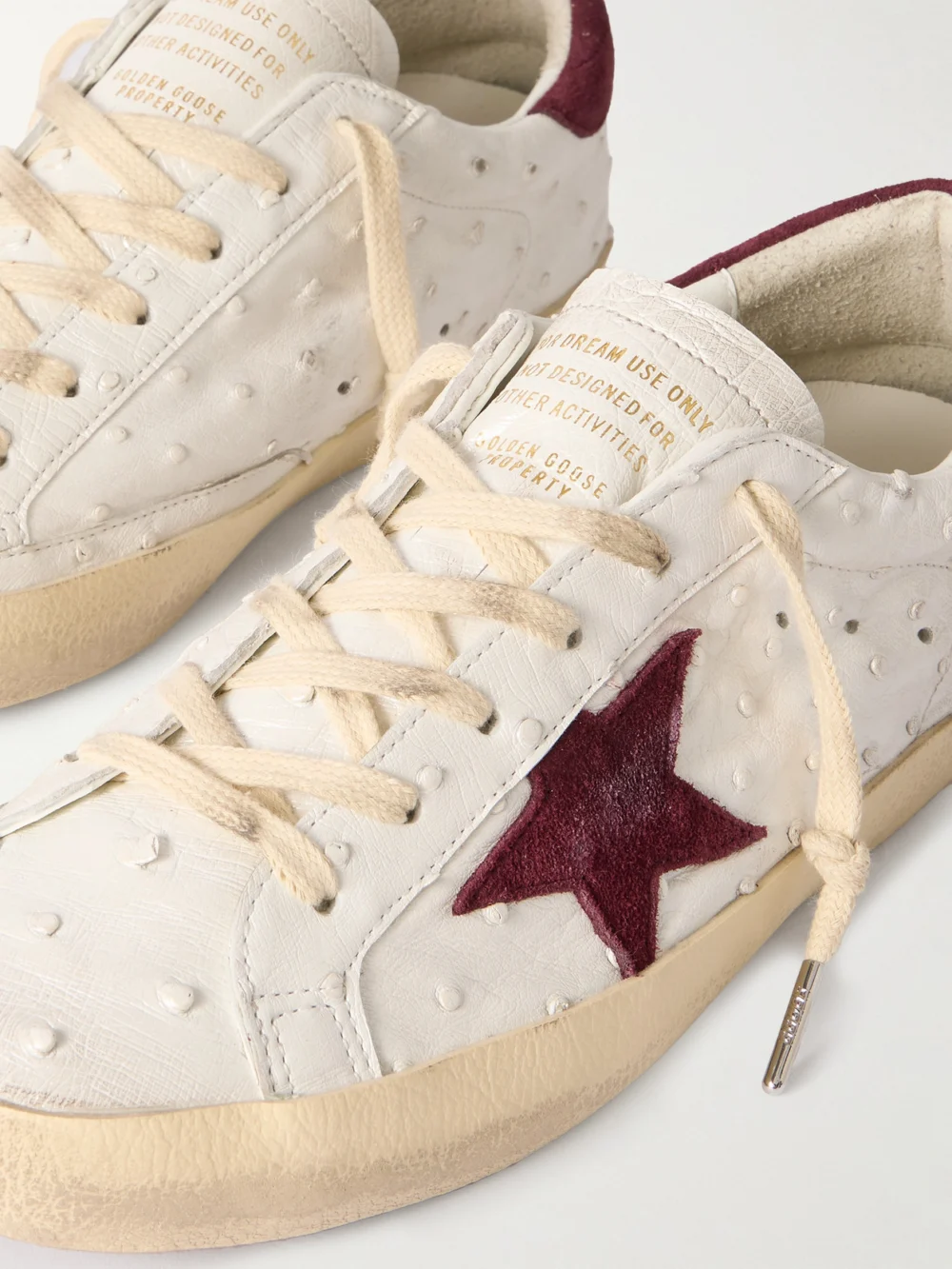 Close-up detail of the Golden Goose Super-star Distressed Ostrich and Suede Sneakers