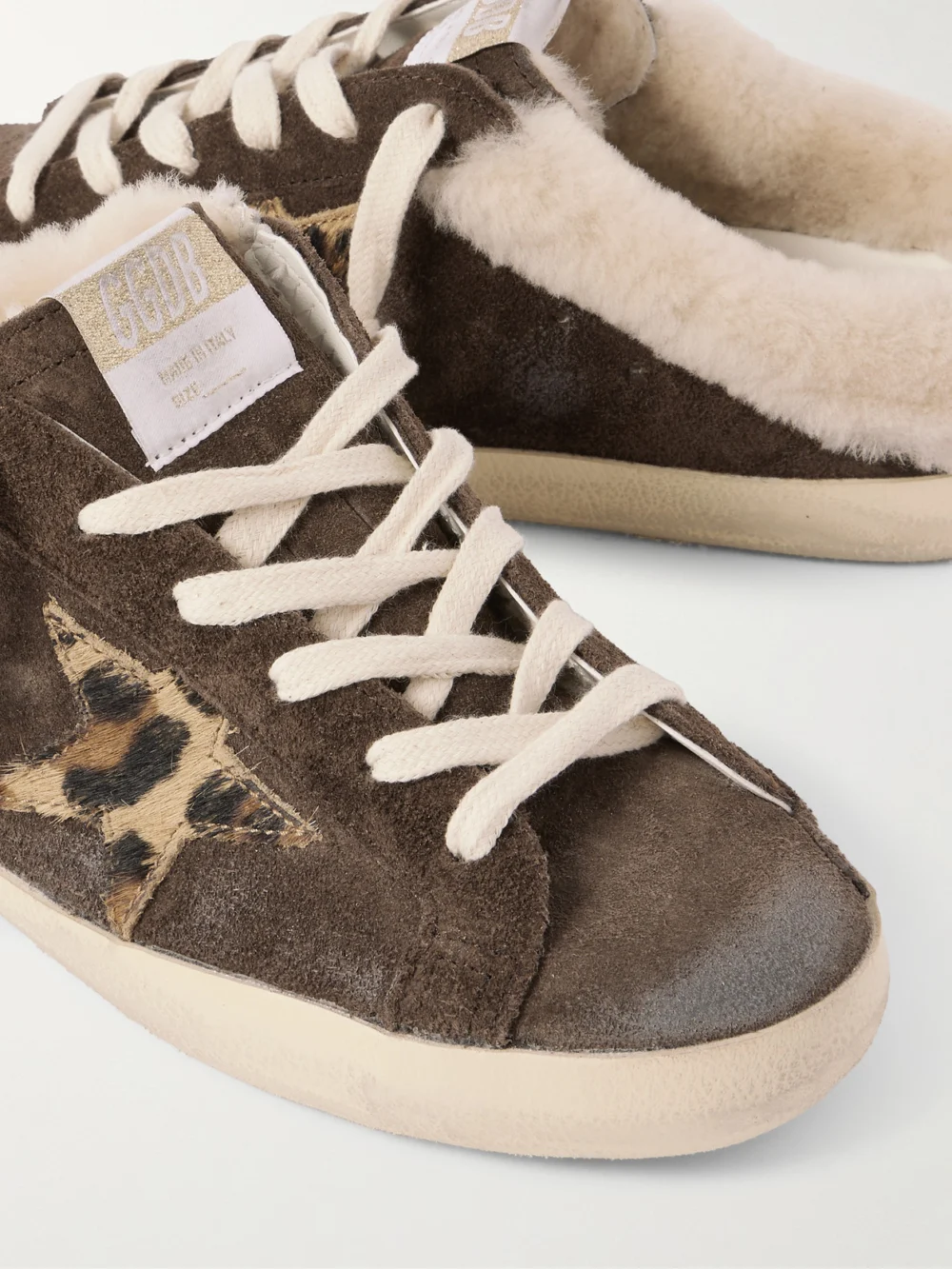 Close-up detail of the Golden Goose Super-star Sabot Shearling-lined Calf Hair-trimmed Distressed Suede Slip-on Sneakers