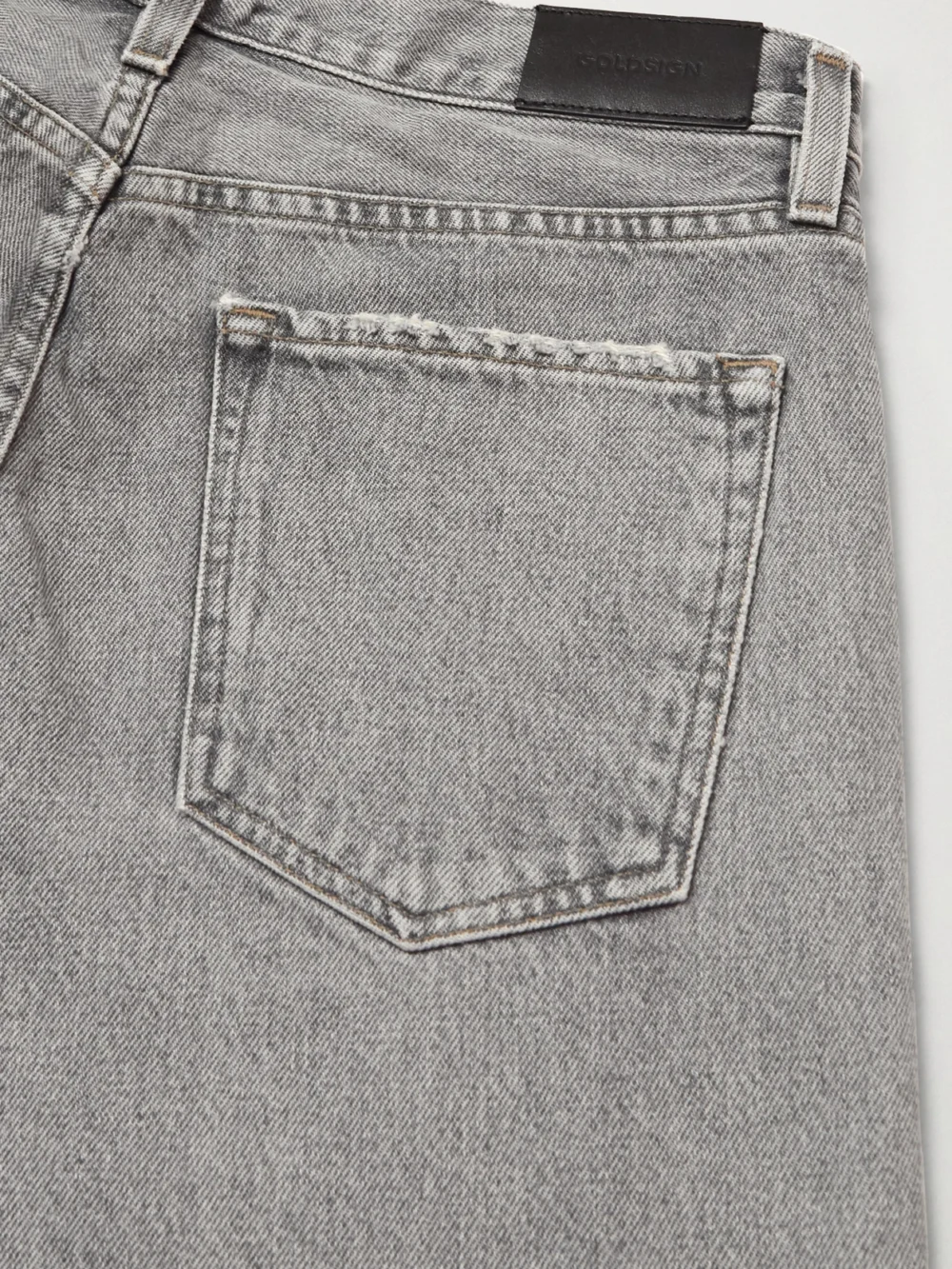 Close-up detail of the Goldsign The Walcott Distressed Straight-leg Organic Jeans
