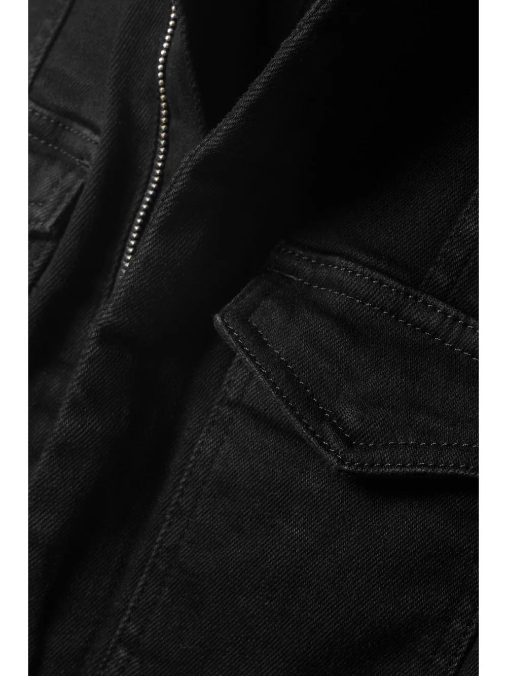 Close-up detail of the Good American Fit for Success Stretch-denim Jumpsuit