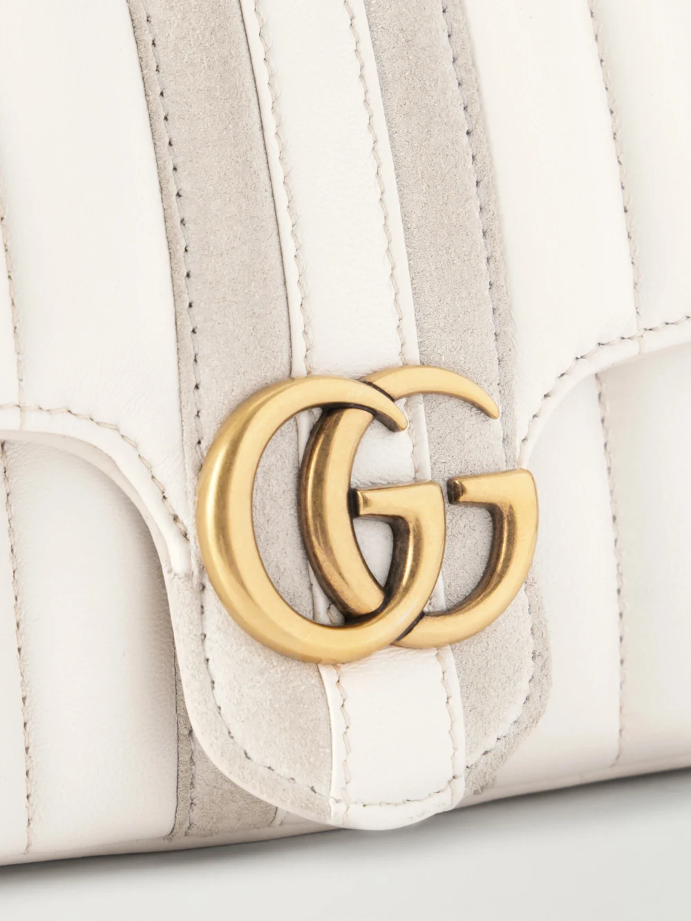 Close-up detail of the Gucci Gg Marmont Jetset Suede-trimmed Quilted Leather Crossbody Bag