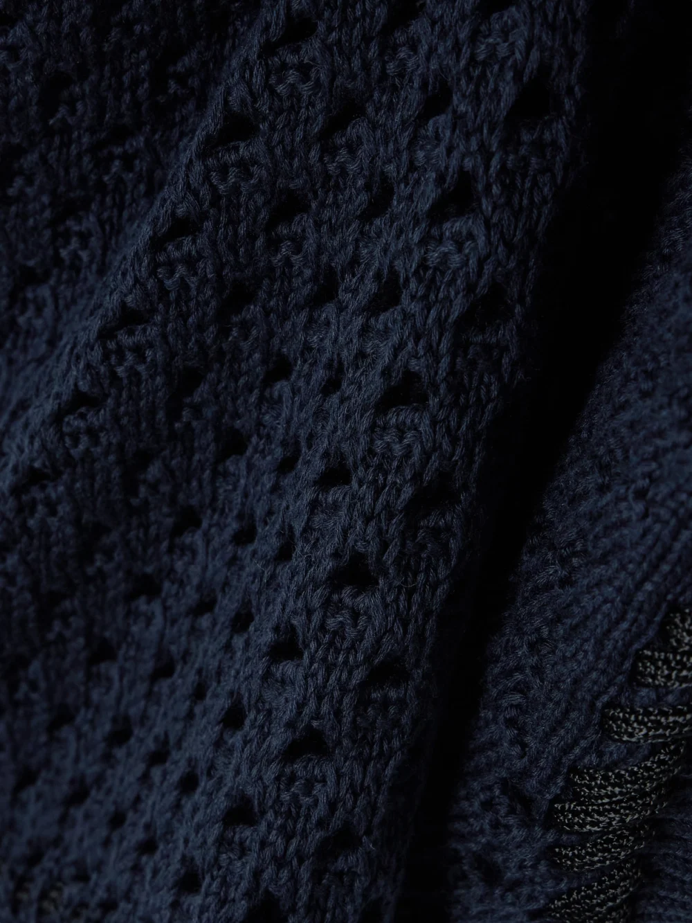 Close-up detail of the Guest In Residence Cropped Open-knit Cotton Vest