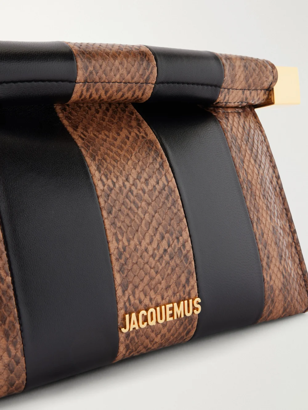Close-up detail of the Jacquemus Le Sac Ronde Carré Two-tone Paneled Snake-effect and Leather Clutch