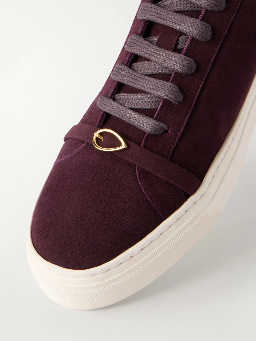 Close-up detail of the Jennifer Chamandi Embellished Suede Sneakers