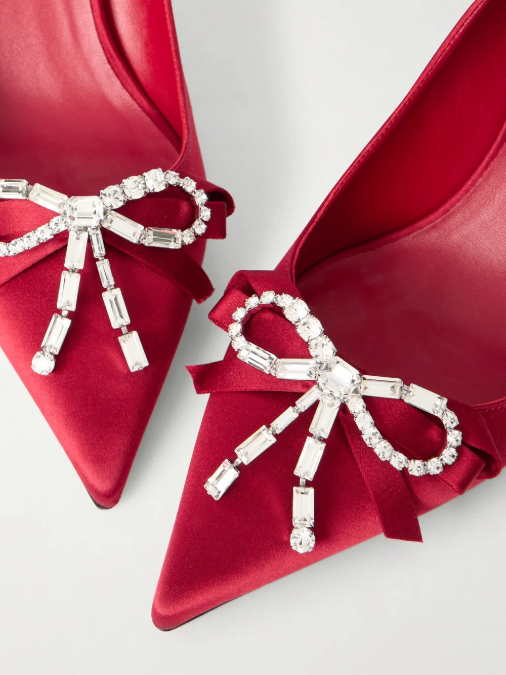 Close-up detail of the Jimmy Choo Aura 70 Crystal Bow-embellished Satin Pumps
