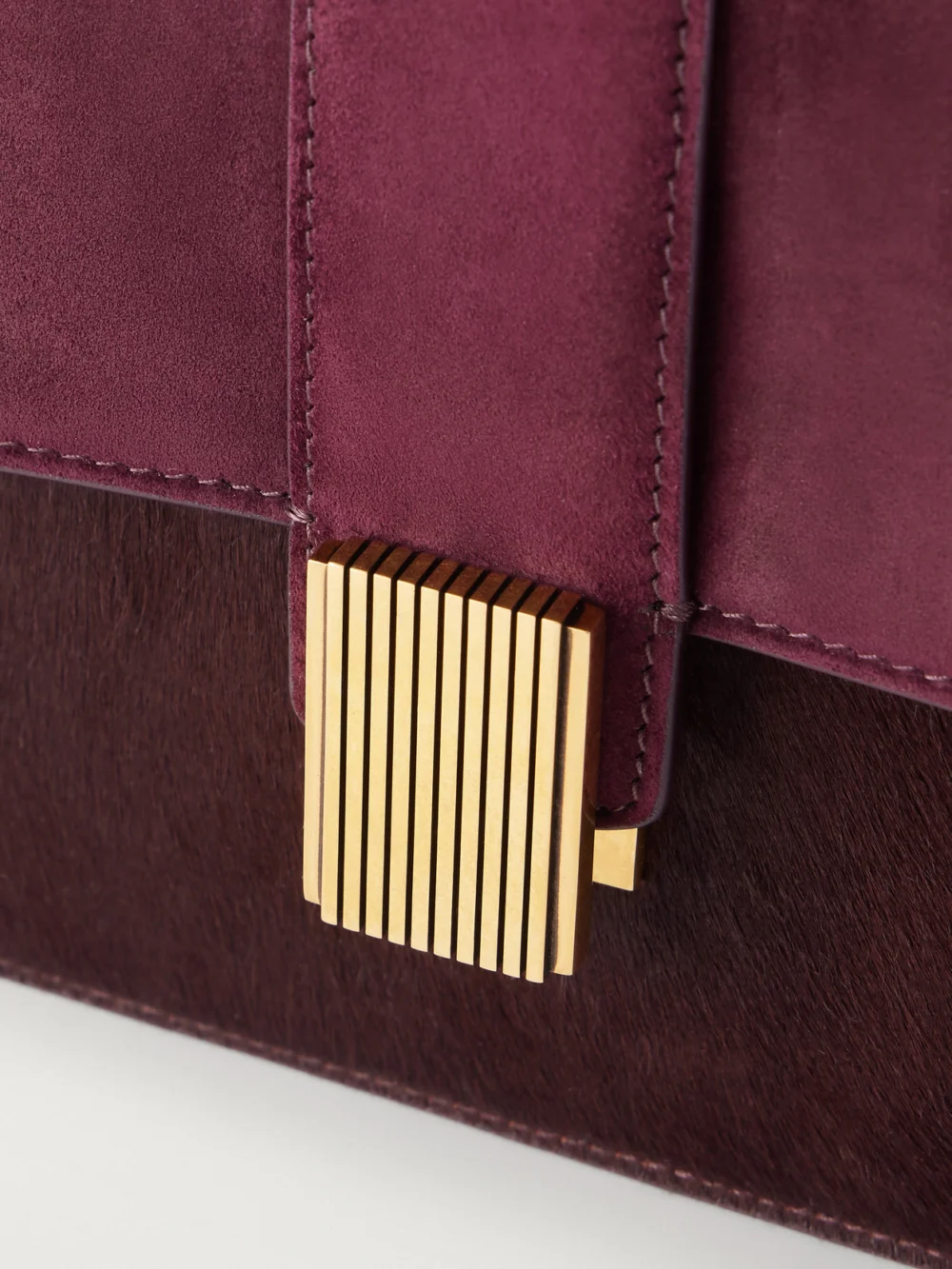 Close-up detail of the Khaite Blake Calf Hair-trimmed Suede Shoulder Bag