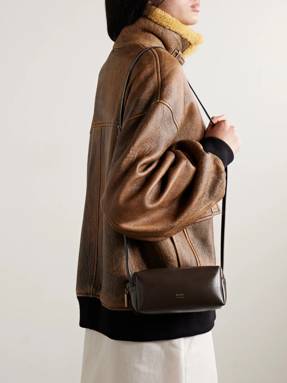 Khaite Kye Glossed-leather Shoulder Bag, styled view