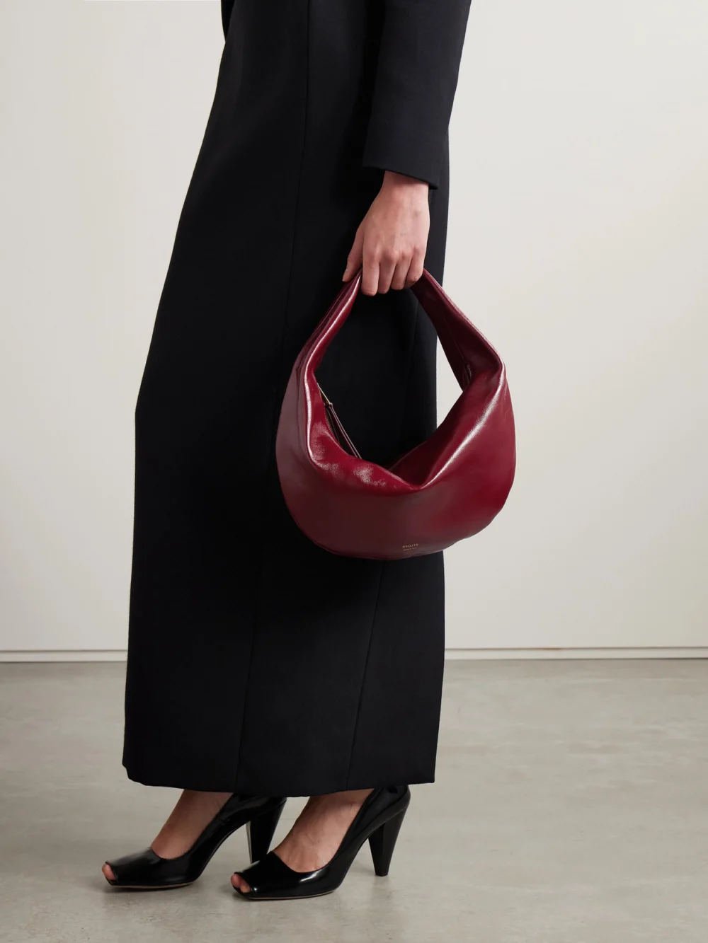 Khaite Olivia Medium Crinkled Patent-leather Top-handle Bag, styled view