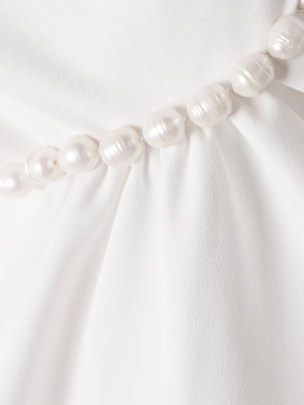 Close-up detail of the Kika Vargas Fiona Strapless Faux Pearl-embellished Twisted Twill Mini Dress