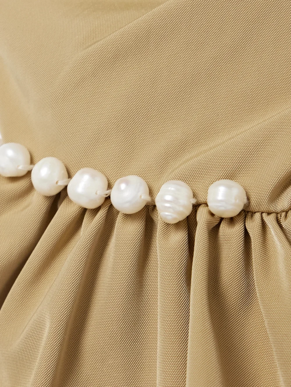 Close-up detail of the Kika Vargas Hebe Strapless Faux Pearl-embellished Woven Top