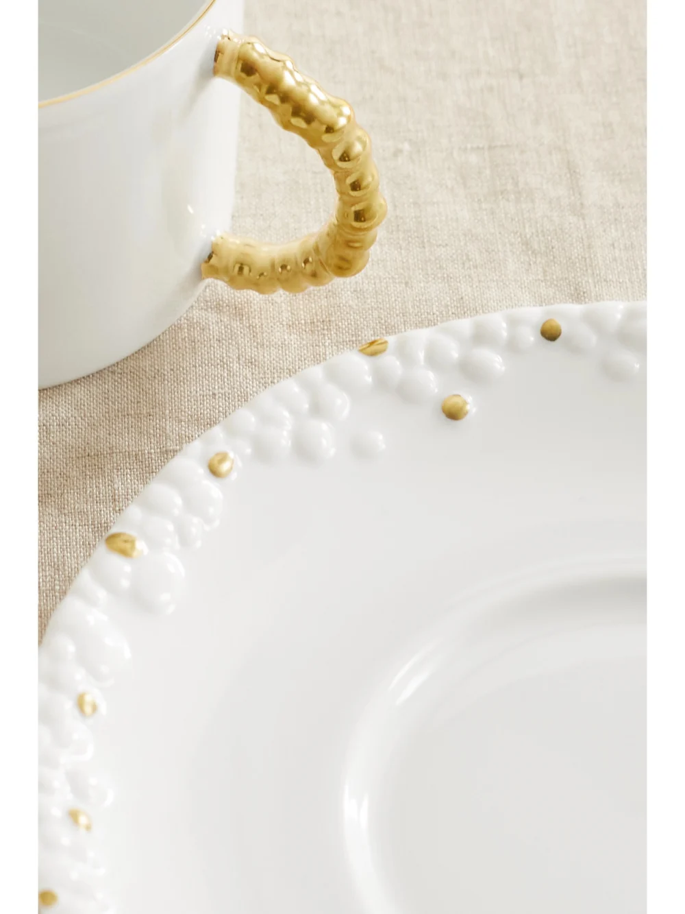 Close-up detail of the L'Objet + Haas Brothers Mojave Set of Two Gold-plated Porcelain Tea Cups and Saucers