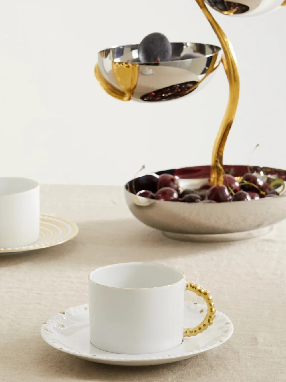 L'Objet + Haas Brothers Mojave Set of Two Gold-plated Porcelain Tea Cups and Saucers, styled view