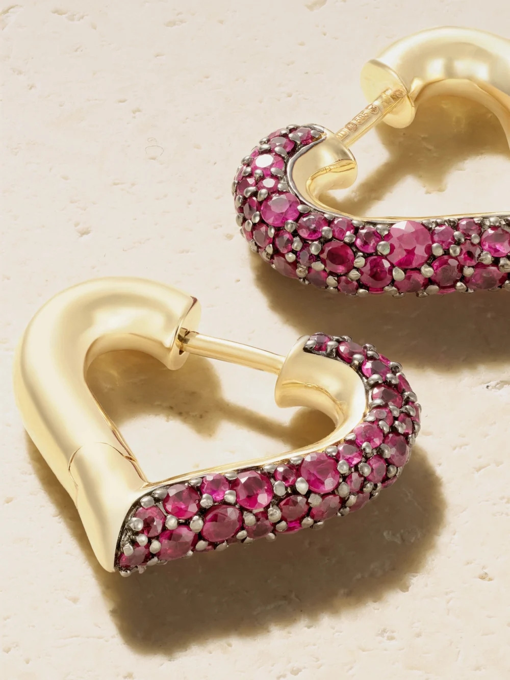 Close-up detail of the Lucy Delius Baby Chubby Love 14-karat Gold Ruby Earrings