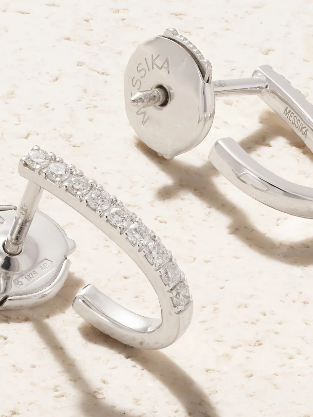 Close-up detail of the Messika Gatsby Xs 18-karat White Gold Diamond Hoop Earrings