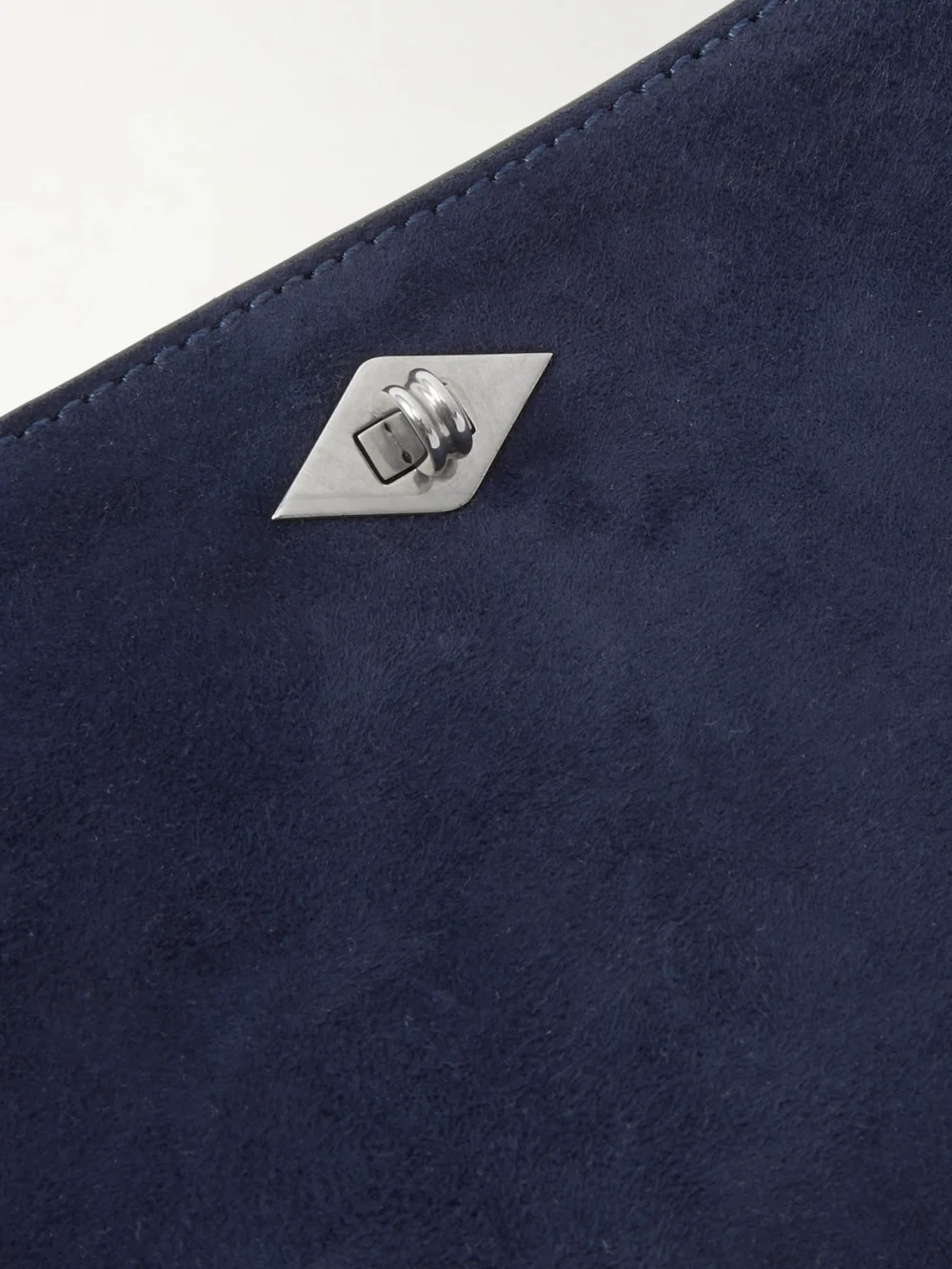 Close-up detail of the Métier Ease 22 Suede Clutch