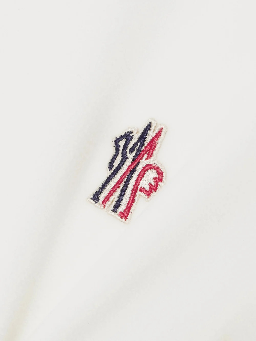 Close-up detail of the Moncler Grenoble Appliquéd Hooded Fleece Jacket