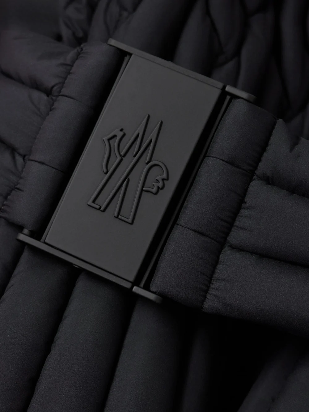 Close-up detail of the Moncler Grenoble Maipo Appliquéd Belted Quilted Padded Shell Down Ski Jacket