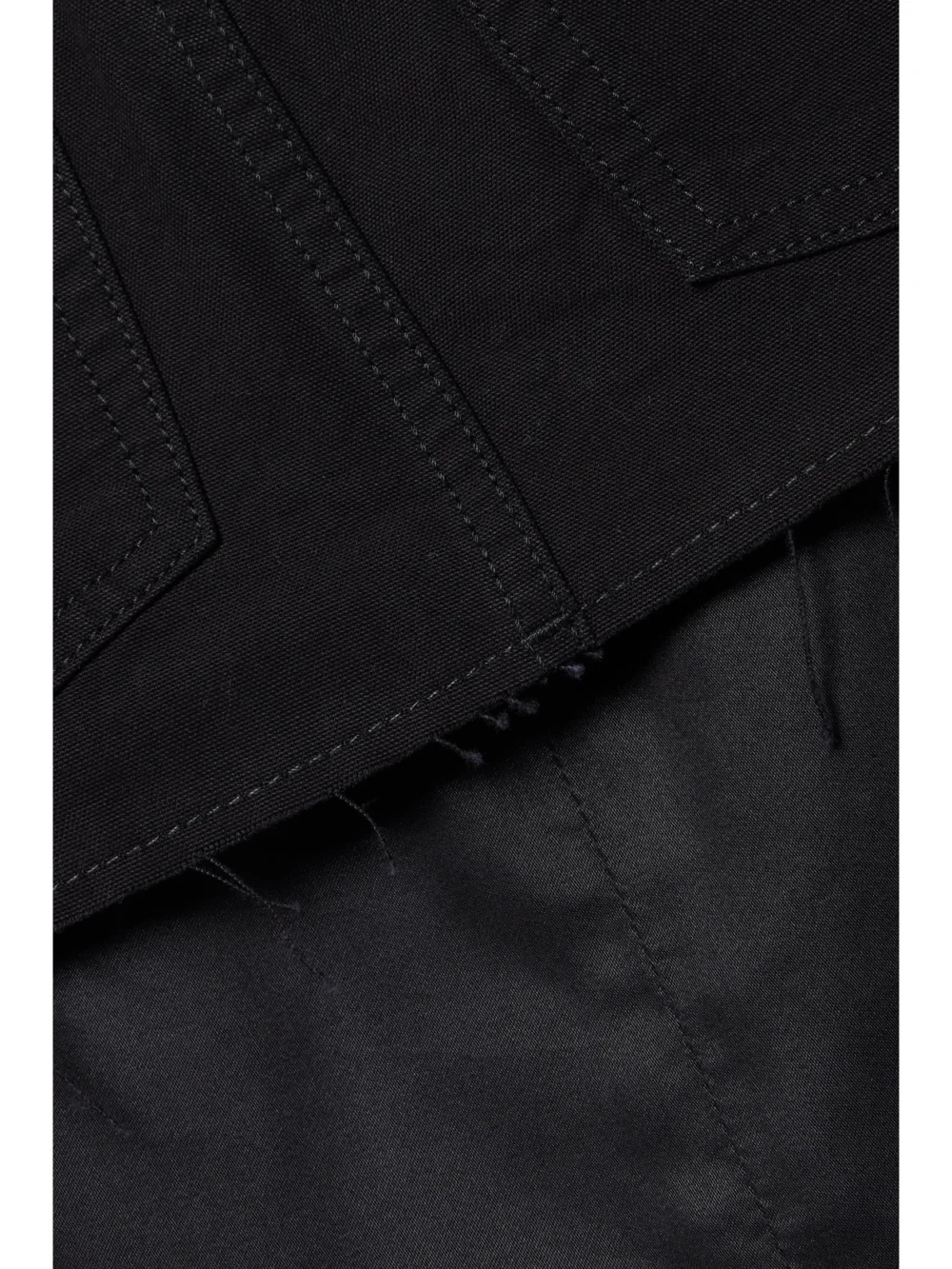 Close-up detail of the Our Legacy Layered Tencel™ Lyocell and Denim Mini Skirt