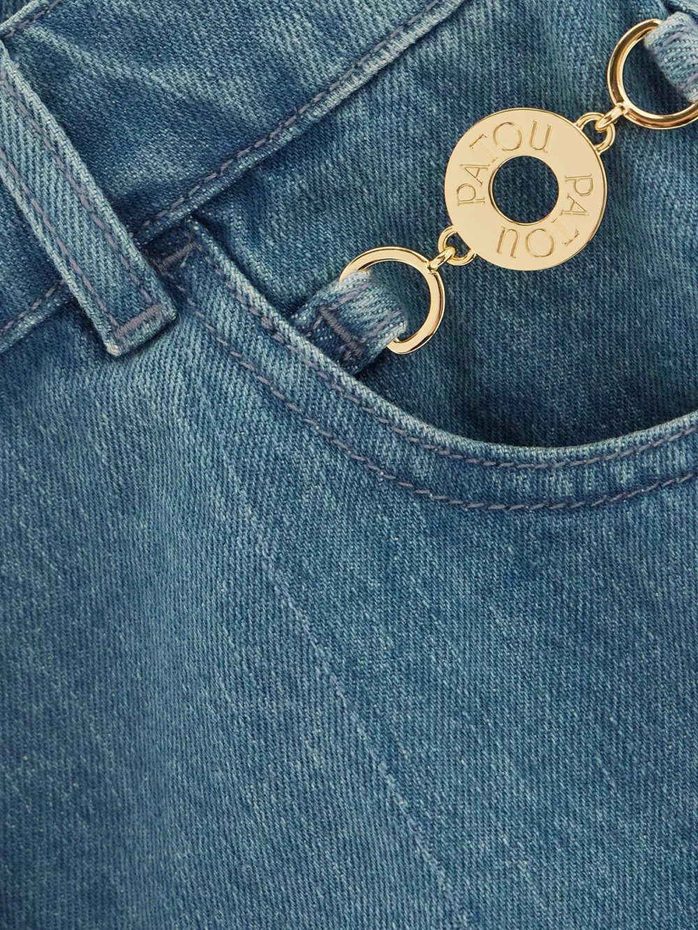 Close-up detail of the Patou Embellished Denim Shorts