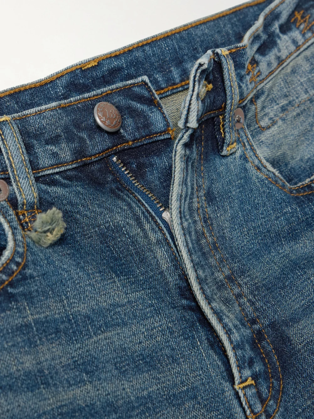 Close-up detail of the R13 Charlotte Distressed High-rise Flared Jeans