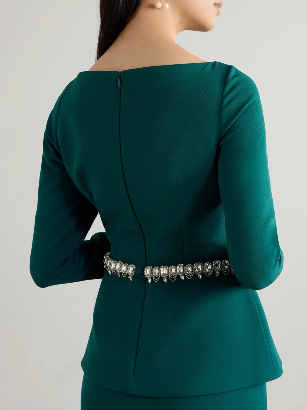 Back view of the Safiyaa Manya Belted Draped Crystal-embellished Stretch-crepe Peplum Blouse