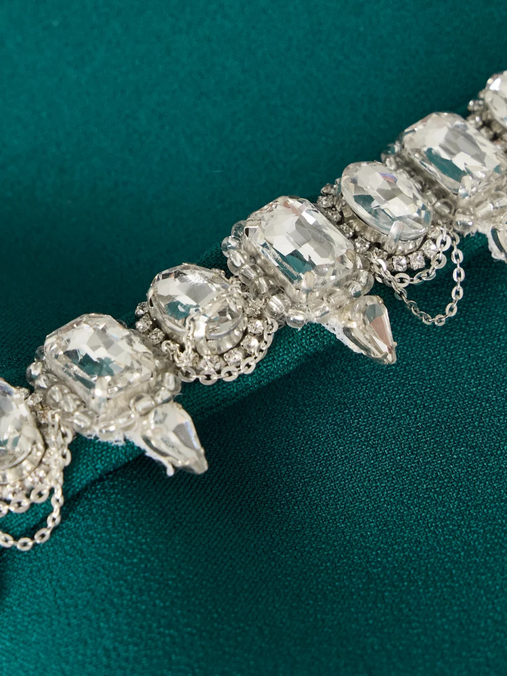 Close-up detail of the Safiyaa Manya Belted Draped Crystal-embellished Stretch-crepe Peplum Blouse